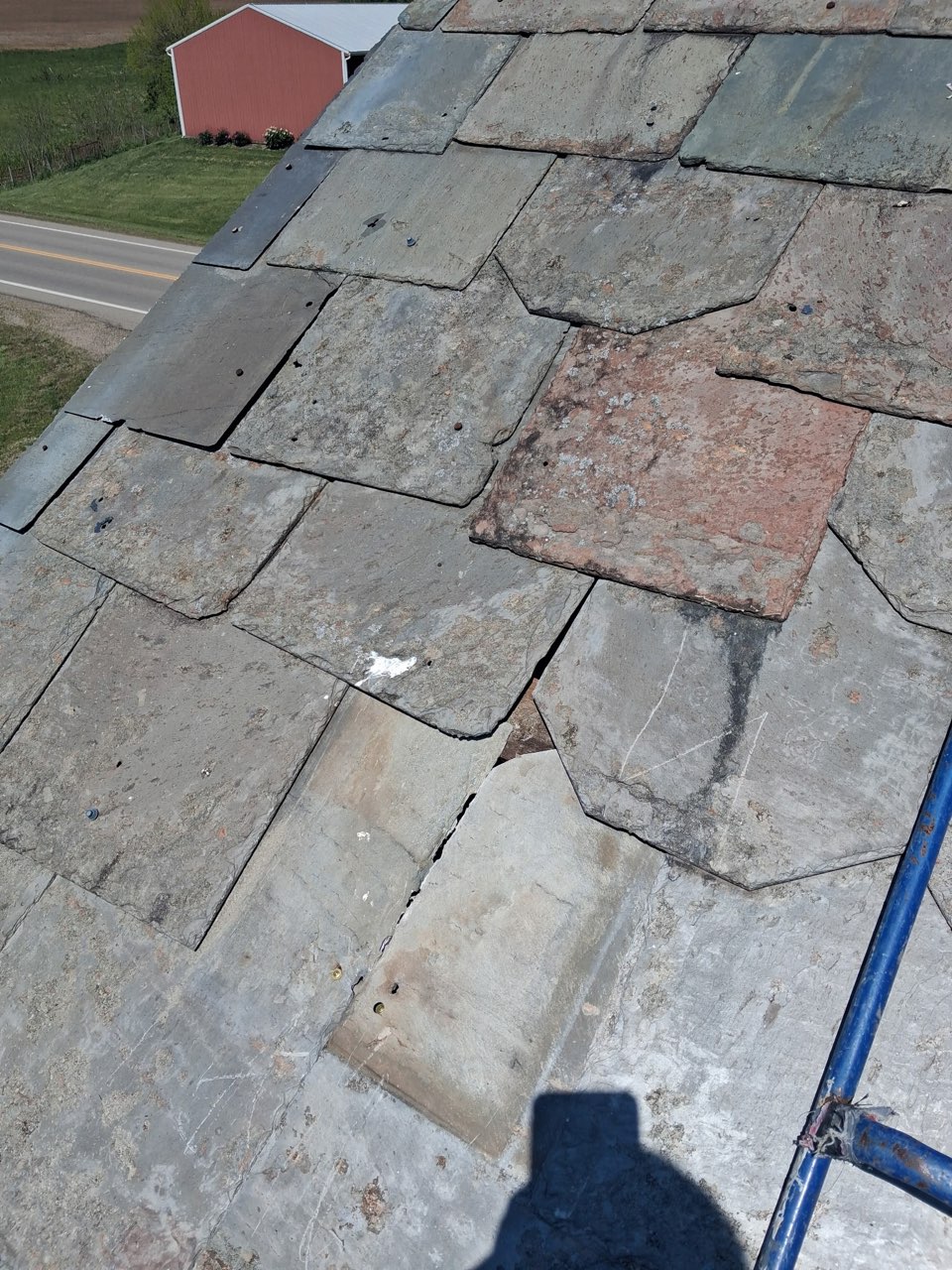 After slate roof repair showing restored slate roof surface with weathered slate tiles